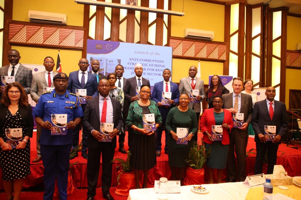 Members of the National Council on the Administration of Justice (NCAJ) led by Chief Justice Martha Koome pose for a photo with copies of the newly launched National Council on the Administration of Justice (NCAJ) Anti-Corruption Strategic Guiding Framework for fighting corruption at a Nairobi hotel on March 25, 2025. Photo by Clinton Ng’iela.